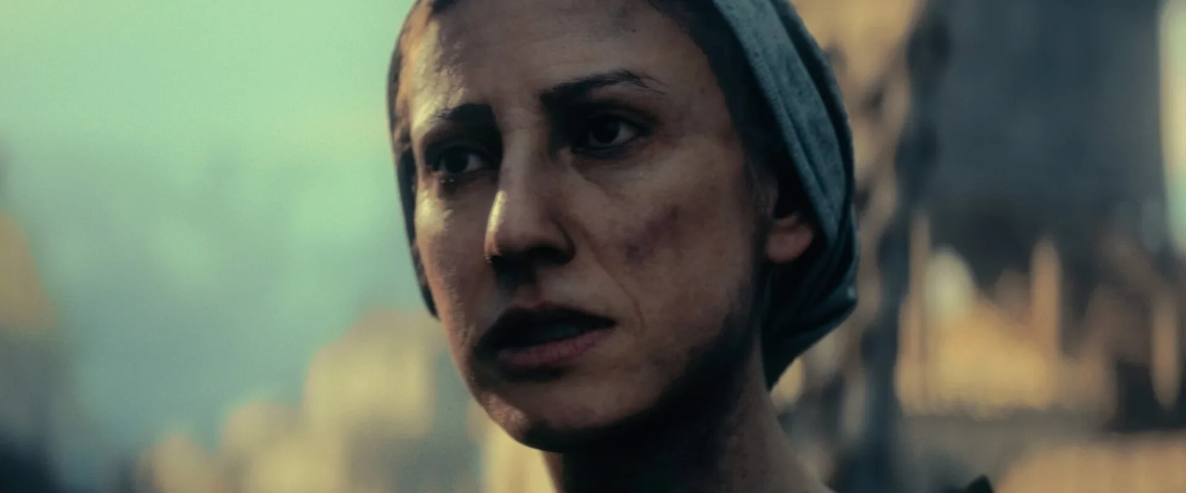 A close portrait of a worried woman in a headscarf.
